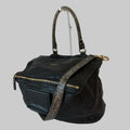 Black textured handbag with gold accents on a white background